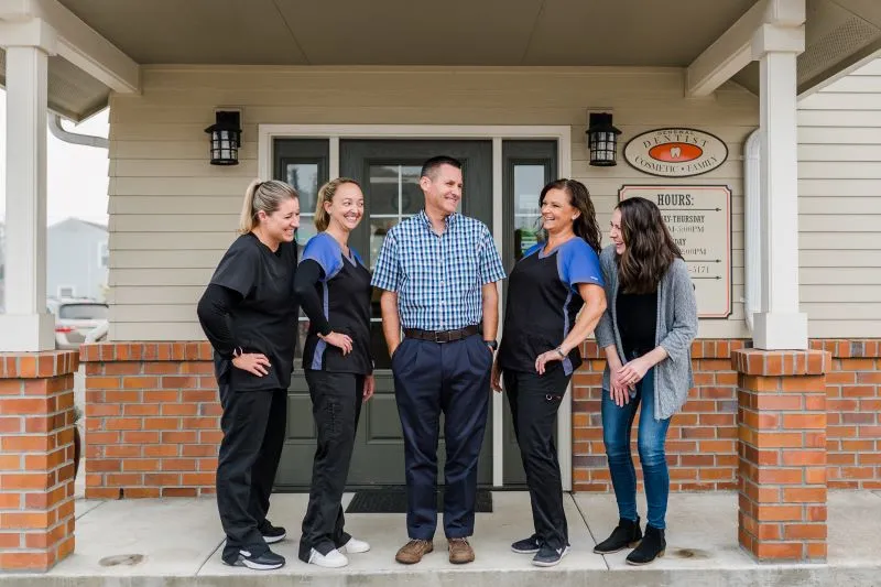 Staff together in front of the office